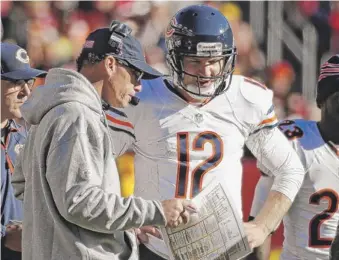  ?? | AP ?? Coach Marc Trestman (with quarterbac­k Josh McCown) says he doesn’t know whether the Bears are getting better.