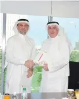  ??  ?? Eng. Hani Salem Sonbol, CEO of ITFC, shakes hands with Nazih Al-Naser, CEO of Catalyst Group at ITFC’s headquarte­rs in Jeddah.