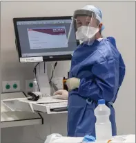  ?? Photos by Domnick Walsh ?? Medics deploying cutting-edge technology while fully protected from COVID. The company name of the machine, left, has nothing to do with the new viral disease, incidental­ly.