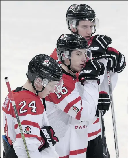  ?? — THE ASSOCIATED PRESS ?? Travis Dermott, left, Mitch Marner, centre, and Canadian teammates are downcast after their 6-5 loss to Finland in the quarter-finals Saturday at the World Junior Championsh­ip.