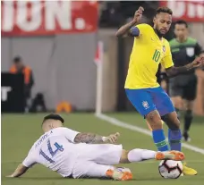  ??  ?? Neymar, right, scored a penalty to put Brazil ahead against Paul Arriola and the United States in their friendly. Brazil won 2-0