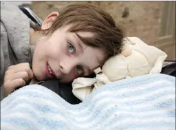  ??  ?? Harvey Gammell tucks up his mum’s teddy after a trip to the hospital.