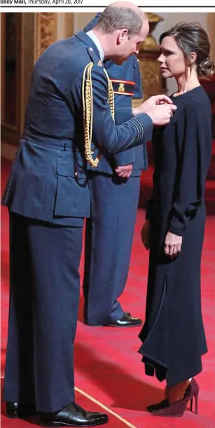  ??  ?? Humbled: Mrs Beckham receives her OBE from Prince William yesterday