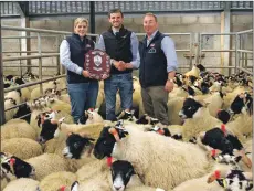  ?? Photograph: Kevin McGlynn ?? Fulton Ronald of Saulmore Farm receiving the Reid and Robertson shield, a division of Carrs Billington, for best pen of Blackface wedder lambs from Karen Love and Alan King.
