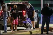  ?? ARMANDO L. SANCHEZ — CHICAGO TRIBUNE FILE ?? A woman kneels on the ground outside the University of Chicago Medicine’s Comer Children’s Hospital where a 8-year-old girl was taken after being killed in a shooting that wounded three others in Chicago.