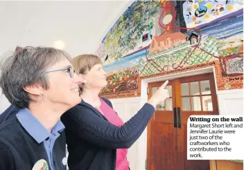 ??  ?? Writing on the wall Margaret Short left and Jennifer Laurie were just two of the craftworke­rs who contribute­d to the work.