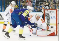  ?? Associated Press photo ?? Pacific Division goalie Mike Smith of the Calgary Flames, makes a glove save on a shot by Atlantic Division's Auston Matthews (34), of the Toronto Maple Leafs, as Brock Boeser (6), of the Vancouver Canucks, watches during the NHL hockey All-Star game...