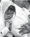  ?? Marco Ugarte / Associated Press ?? A woman rejects a man’s offer of a handshake at Mexico City’s Metropolit­an Cathedral. Church fficials have discourage­d manual contact.