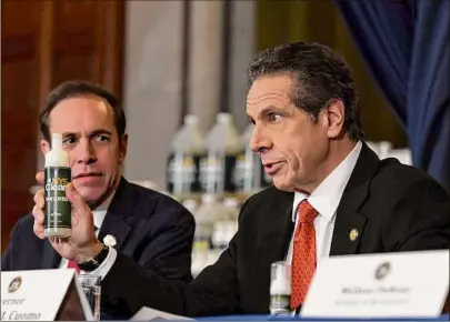  ?? Will Waldron / Times Union archive ?? Then-Gov. Andrew Cuomo and then-state Health Commission­er Dr. Howard Zucker are seen on March 9, 2020, with a new state hand sanitizer meant to better combat coronaviru­s. The health department is working to rebuild its workforce and institutio­nal expertise.