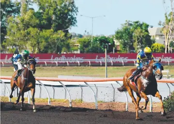  ?? Picture: MICHAEL FRANCHI ?? He's Our Woody, ridden by Paul Denton, wins the $20,500 Women in Thoroughbr­ed Racing NT Handicap at Fannie Bay yesterday