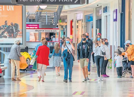  ??  ?? Shoppers venture into the Overgate for the first time since lockdown restrictio­ns were introduced in March.