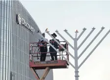  ??  ?? DIRECTOR at Discovery Group Barry Swartzberg (left) and Rabbi Ari Kievman light a 7m-high menorah – the tallest in Africa – for the festival of Chanukah in Sandton. It will be lit at 6.30pm every day until Sunday. |