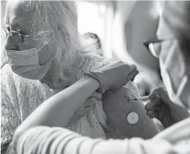  ?? ALISHA JUCEVIC/THE NEW YORK TIMES ?? Elizabeth Gillander, 78, gets a booster shot of the Pfizer-BioNTech COVID-19 vaccine last week at a mobile clinic in McMinnvill­e, Oregon.