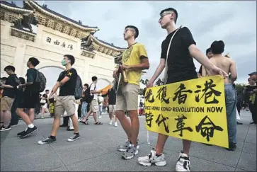  ?? Chiang Ying-ying Associated Press ?? PROTESTERS from Hong Kong and Taiwan gather last week at Democracy Square in Taipei to mark the first anniversar­y of a mass rally in Hong Kong against its now-withdrawn extraditio­n bill.