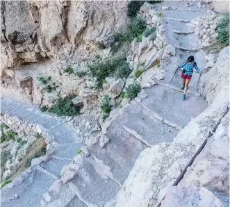  ??  ?? Hiker Dina Mishev begins her descent into the Grand Canyon from the top of the South Kaibab Trail, the most direct route to the bottom of the canyon, which is big on views but short on shade.