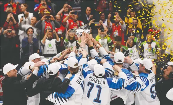  ?? VLADIMIR SIMICEK/AFP/GETTY IMAGES ?? Finland won the IIHF Men’s Ice Hockey World Championsh­ips against Canada last May in Slovakia but will not get a chance to defend the title this year.