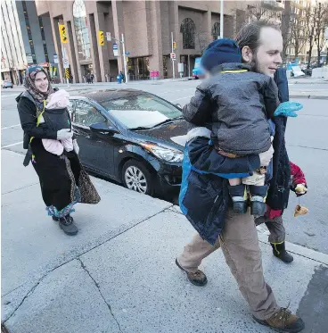  ?? WAYNE CUDDINGTON ?? Caitlan Coleman, seen walking with husband Joshua Boyle and their three children in downtown Ottawa, has alleged that Joshua abused her during their five years in captivity with a Taliban-linked group in Pakistan and Afghanista­n.