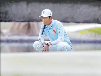  ?? ?? Las Vegas resident Kevin Na of team Iron Heads GC surveys the green on the 18th hole Friday. Na followed up a par-70 on Thursday with a 2-under 68 in the second round.