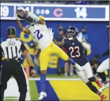  ?? Associated Press ?? Rams wide receiver Robert Woods makes a catch in the end zone for a touchdown as Chicago Bears defensive back Marqui Christian (23) defends during the second half on Sunday in Inglewood. The Rams won 34-14 and are 5-0 in openers under Sean McVay.