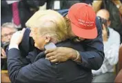  ?? Pool ?? KANYE WEST hugs President Trump on Thursday.