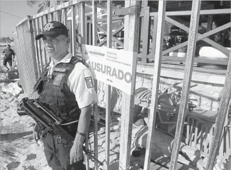  ?? Associated Press ?? THE ENTRANCE of the Blue Parrot nightclub in Playa del Carmen, Mexico, is under guard after the shooting during what had been a celebrator­y finale of a 10-day internatio­nal electronic music festival known as BPM, for Bartenders, Promoters, Musicians.