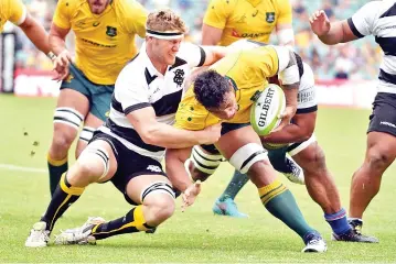  ?? — AFP photo ?? Australia's Lopeti Timani is tackled by Barbarians' Ben McCalman (L) during their rugby union match in Sydney on October 28, 2017.