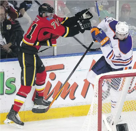  ?? TED RHODES/ CALGARY HERALD ?? Calgary Flames prospect Hunter Smith, left, said he wants to be looked at as a hard worker and wants to challenge for a roster spot when he attends the team’s developmen­t camp next week. He was the team’s 54th overall draft pack in the NHL 2014 draft.
