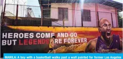  ??  ?? MANILA: A boy with a basketball walks past a wall painted for former Los Angeles Lakers basketball player Kobe Bryant yesterday, following his death overnight in the US. — AFP (See Page 26)