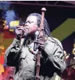  ??  ?? Luciano, lighting up a spliff during his performanc­e at the Peter Tosh tribute concert on Saturday.