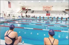  ?? Christian Abraham / Hearst Connecticu­t Media ?? Foran teammates sit at a distance from each other during diving competitio­n at a swim meet in Milford on Thursday.