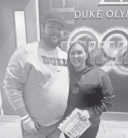  ?? DAVID THOMPSON ?? Growing up in Waterloo, Iowa, Kyle Reisinger became a fan in 1994 when guard Trajan Langdon arrived at Duke. On Christmas morning, his wife, Kayla, made his dream come true.