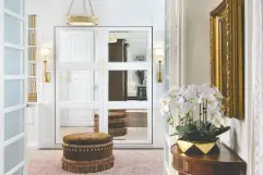  ?? LARRY ARNAL, INFO@ARNALPHOTO­GRAPHY ?? A custom wall of storage and mirrored Murphy bed designed
to look like an armoire.