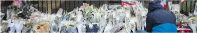  ?? AP ?? Flowers are placed outside police headquarte­rs in Carcassonn­e, France, on Saturday, after a terrorist attacked a supermarke­t.