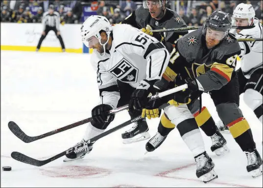  ?? John Locher The Associated Press ?? Golden Knights center Jonathan Marchessau­lt closes in on Los Angeles Kings center Michael Amadio, left, in a battle for the puck in the second period of Vegas’ 2-0 preseason victory Friday at T-Mobile Arena.