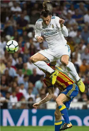  ?? — AFP ?? In full flight: Real Madrid’s forward Gareth Bale heading the ball during the La Liga match against Valencia at the Bernabeu on Sunday.
