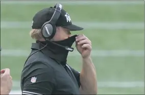  ?? STEVEN SENNE - THE ASSOCIATED PRESS ?? Las Vegas Raiders head coach Jon Gruden adjusts his protective mask along the sideline in the second half of an NFL football game against the New England Patriots, Sunday, Sept. 27, 2020, in Foxborough, Mass.