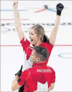  ?? CP PHOTO ?? Canadians Kaitlyn Lawes and John Morris react after defeating Switzerlan­d to win gold during mixed doubles curling action at the 2018 Olympic Winter Games in Gangneung, South Korea, on Feb. 13.