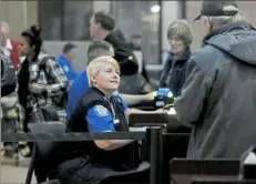  ?? Pam Panchak/Post-Gazette ?? Rebecca Wayne with TSA checks a passenger through security Thursday at the Pittsburgh Internatio­nal Airport Thursday in Moon.