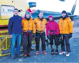  ?? ICEFIELD DISCOVERY TOURS / LANCE GOODWIN / THE CANADIAN PRESS ?? Climber Natalia Martinez, second from right, is seen Thursday after her rescue. With her are, from left, pilot Ian Pitchforth, and members of the Kluane National Parks rescue crew Sarah Chisholm, Scott Stewart, and David Blakeburn.