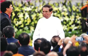  ?? PRAKASH SINGH/AFP ?? Sri Lanka’s suspended police chief (not pictured) accused President Maithripal­a Sirisena (centre) of failing to prevent the Easter bombings that killed 258 people.