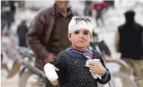  ?? BAKR ALKASEM/AFP VIA GETTY IMAGES ?? Musa Hmeidi, a Syrian child who was pulled from the rubble of a collapsed building Friday in Jindayris, is pictured hours after his rescue.