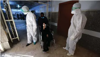  ?? EPA ?? Workers spray disinfecta­nt at Al Kindi Hospital in Baghdad as Iraq battles the Covid-19 pandemic