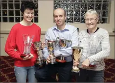  ??  ?? Úna Britton, Brian Gurrin and Ellen Britton with Kilcoole AC’s large haul of trophies.