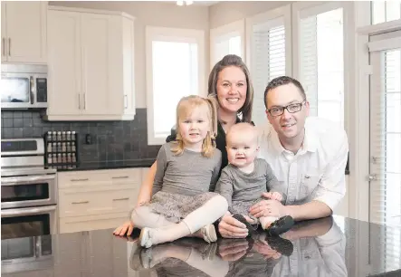  ?? DON MOLYNEAUX/ FOR CALGARY HERALD ?? Benjamin and Jennifer Wood with Paisley and Elliott in their new home by Broadview Homes in Ravenswood.