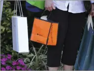  ?? GENE J. PUSKAR THE ASSOCIATED PRESS ?? Shoppers carry their purchases in Bradenton, Fla., on Feb. 9. On Tuesday, the Labor Department said consumer prices rose 0.4% from January to February.