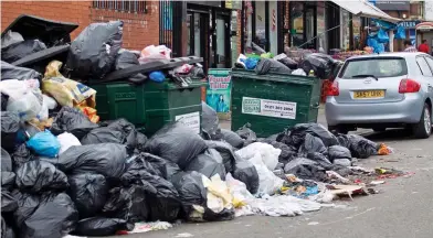  ??  ?? Health hazard: Piles of rubbish are mounting in the streets, attracting rats and flies