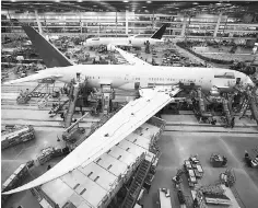  ??  ?? Workers at South Carolina Boeing work on a 787 Dreamliner in North Charleston, South Carolina. Canada’s decision to shun Boeing Co jets could open the way for European rivals seeking to supply new fighters, assuming the government can sort out major...