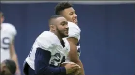  ?? JOE HERMITT — THE ASSOCIATED PRESS ?? Penn State running backs Miles Sanders, left, and Saquon Barkley share a laugh during practice Wednesday.