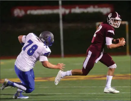  ?? TANIA BARRICKLO — DAILY FREEMAN ?? Kingston quarterbac­k Chapman Parker evades Valley Central’s Daniel Laudati during the Tigers’ game at Dietz Stadium on Friday, Oct. 4, 2019.