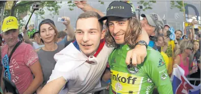  ??  ?? FAN FARE: Peter Sagan (right) poses for a photo with one of his supporters after winning stage 16 of the Tour de France yesterday.